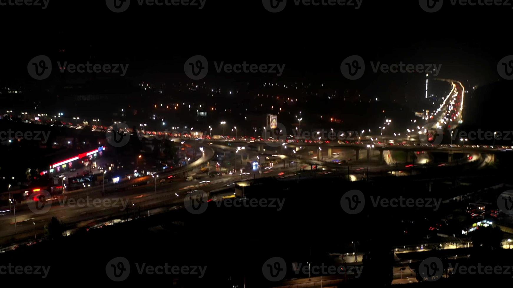 Aerial view of highway interchange at night, timelapse. photo