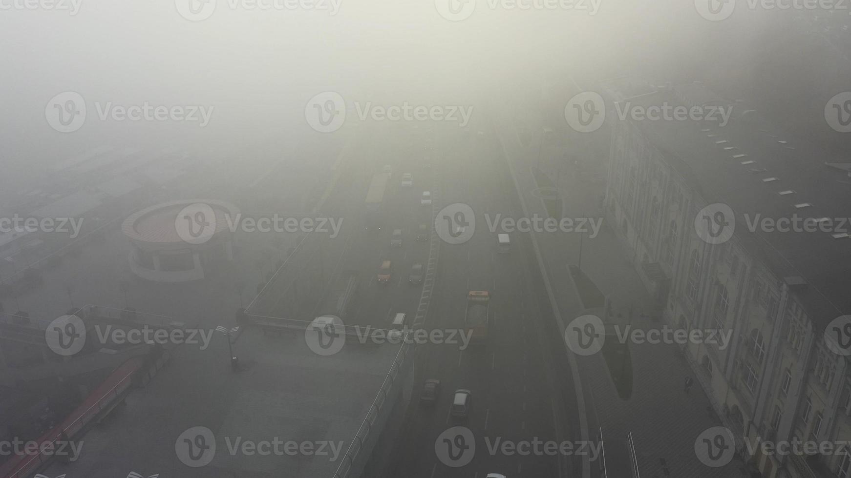 A city covered in fog. City traffic, aerial view photo