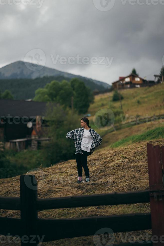 Brunette woman doing exercise while working out at countryside photo