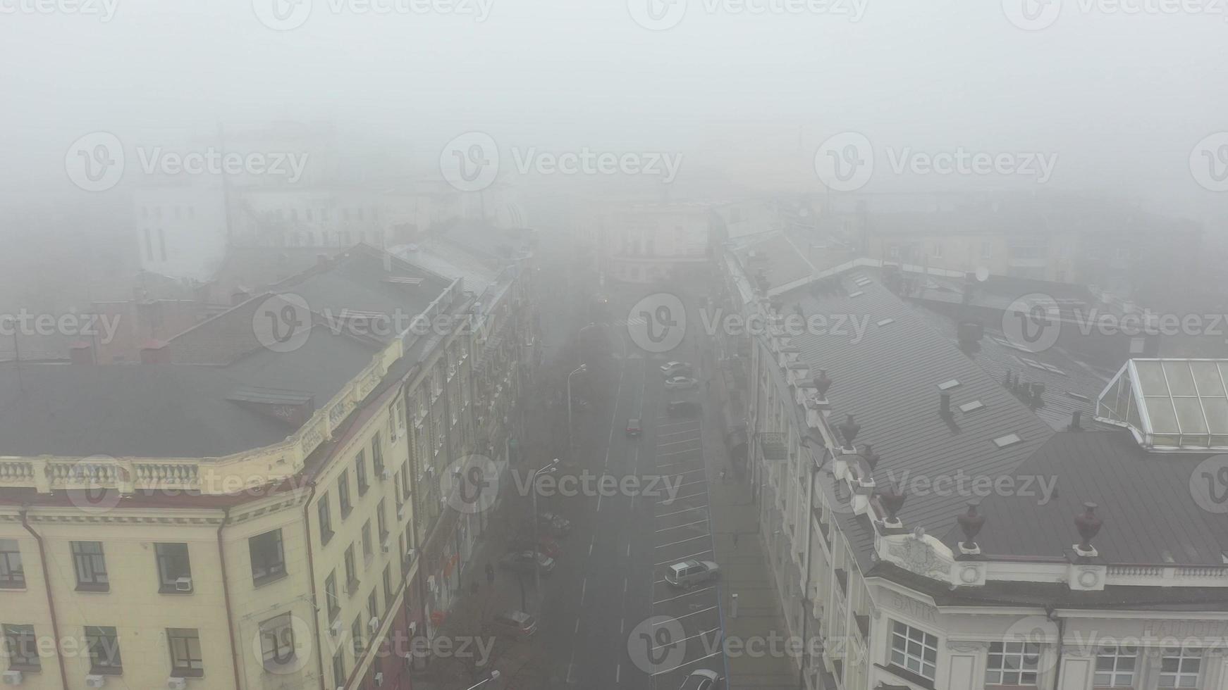 Foggy city street with silhouettes of residential buildings. photo