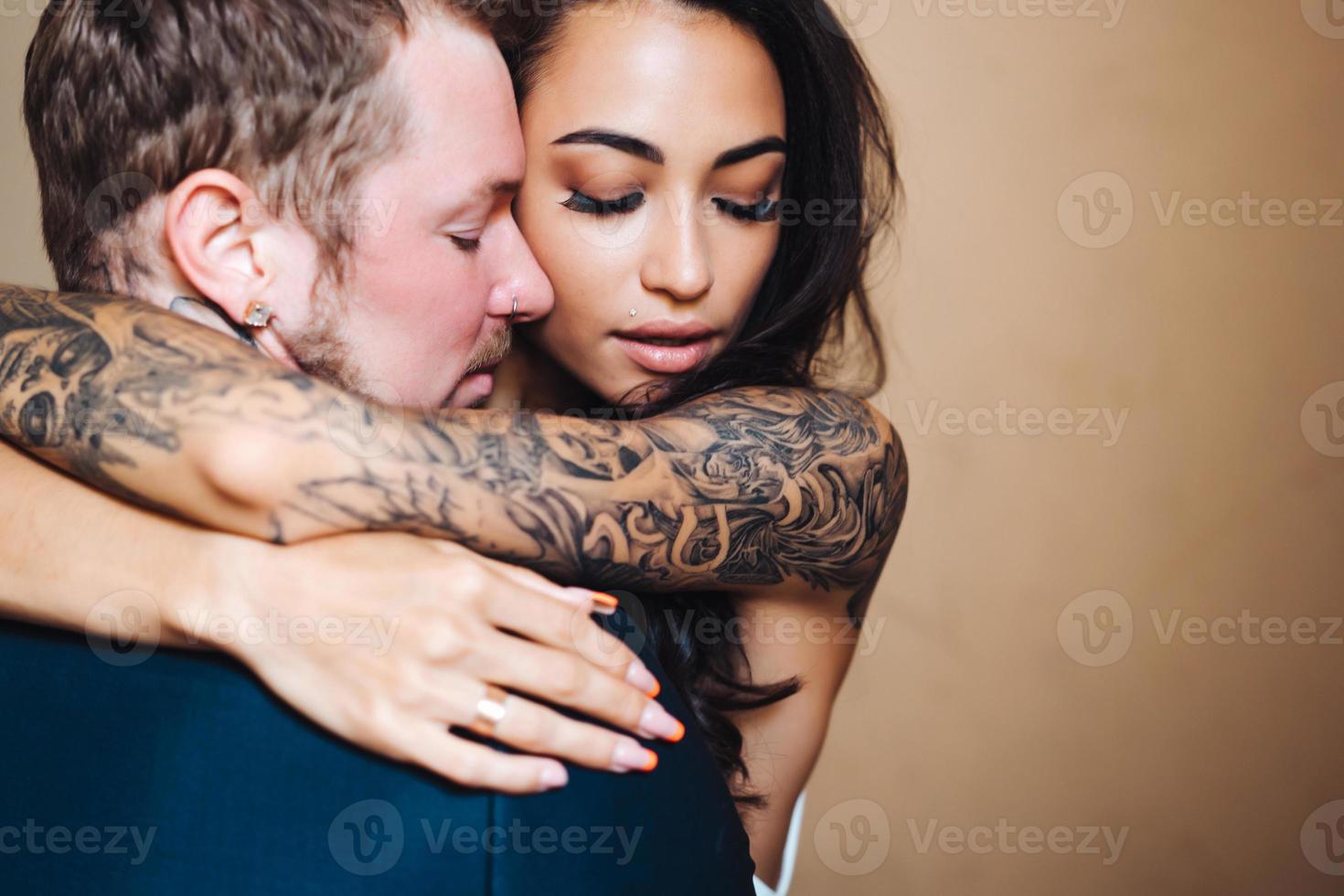 Beautiful, young couple posing on camera indoors photo