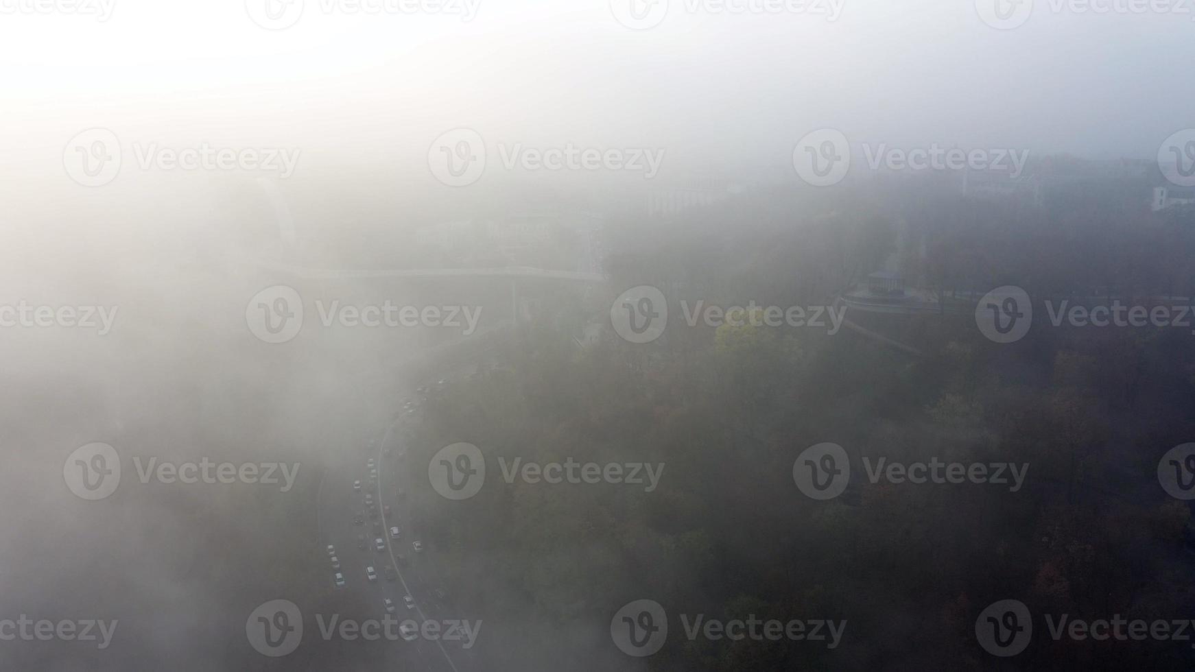 A city covered in fog. City traffic, aerial view photo