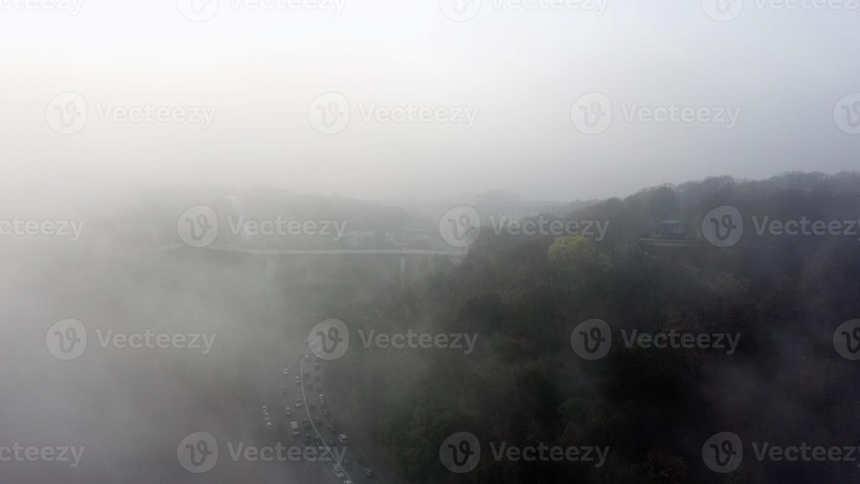 A city covered in fog. City traffic, aerial view photo