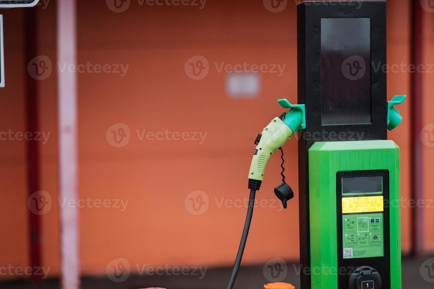 Close up power cord for electric car. Green station photo