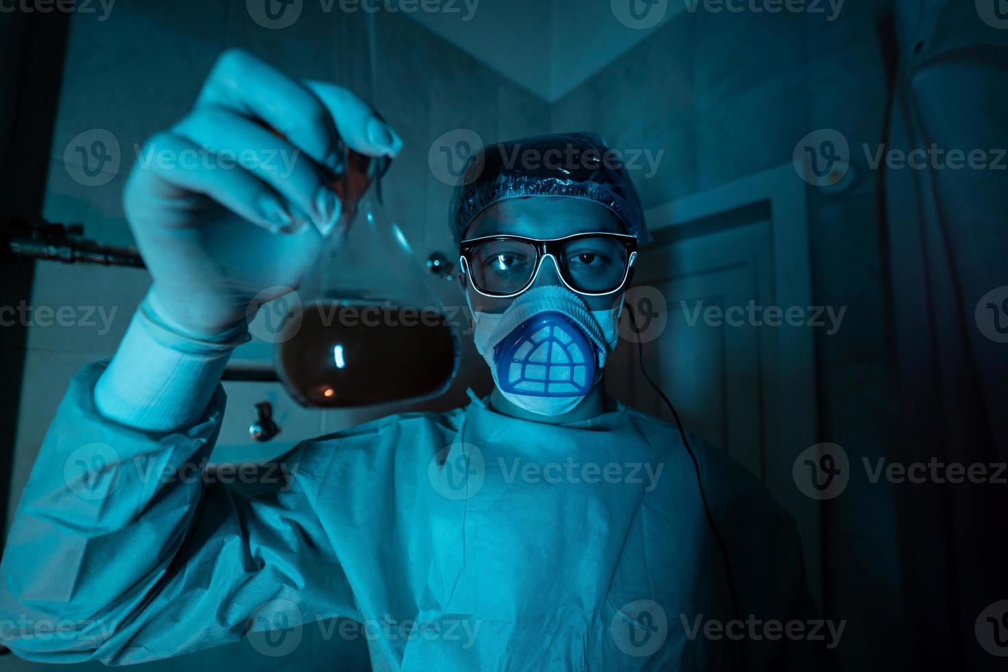 Young male researcher carrying out scientific experiment. photo