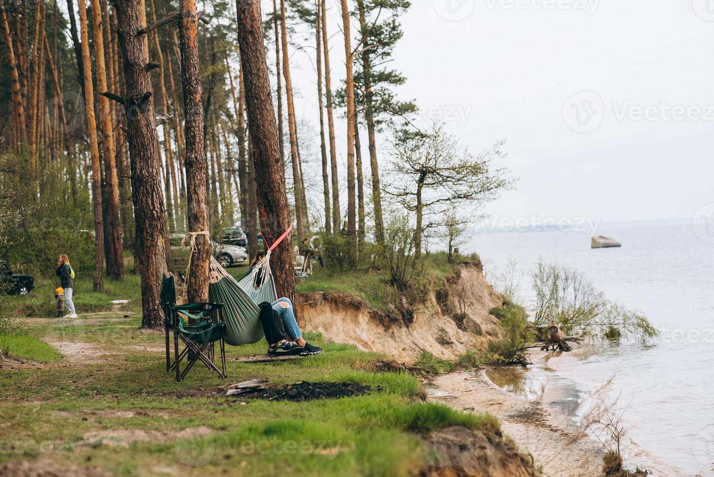 Couple Relaxing in a Hammock Overlooking the Water photo