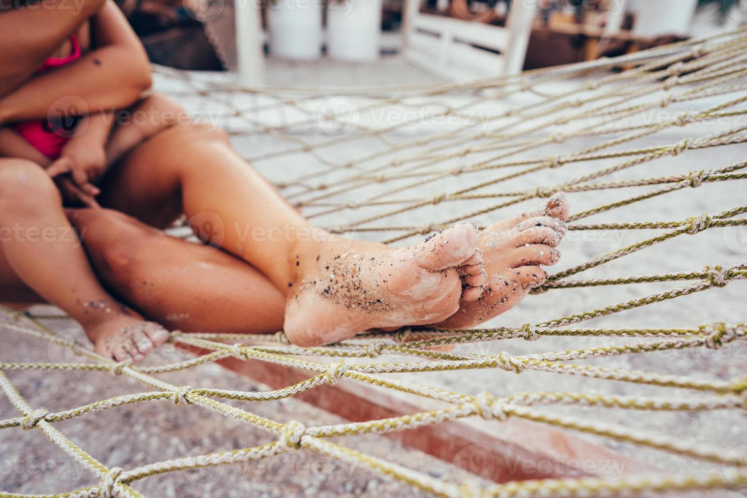 happy mother with her daughter lying in a hammock photo