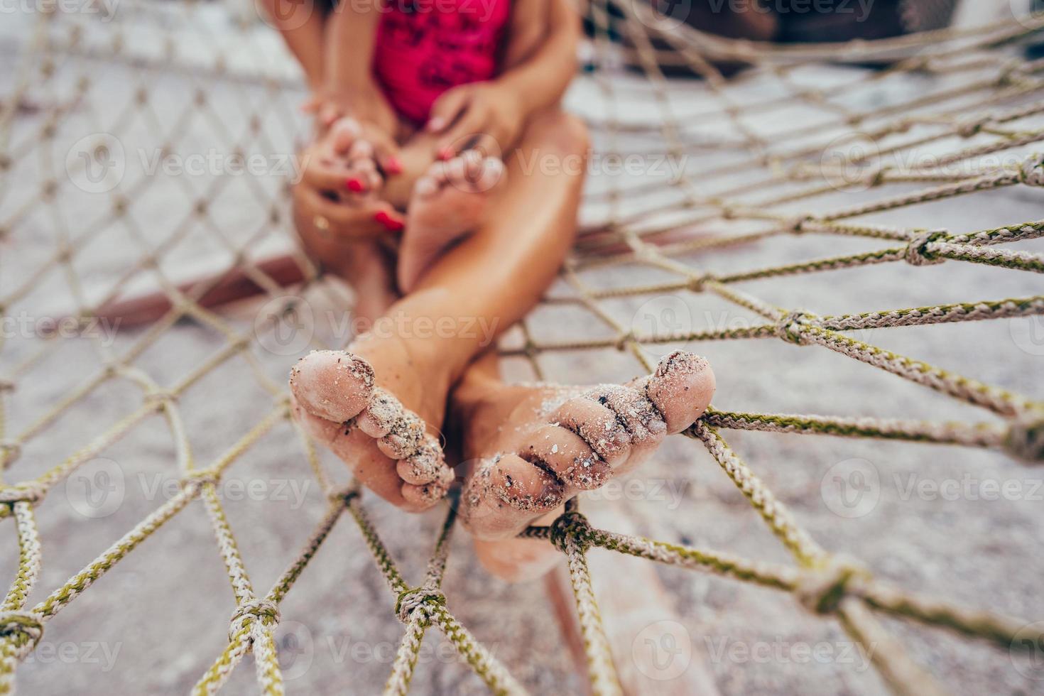 happy mother with her daughter lying in a hammock photo