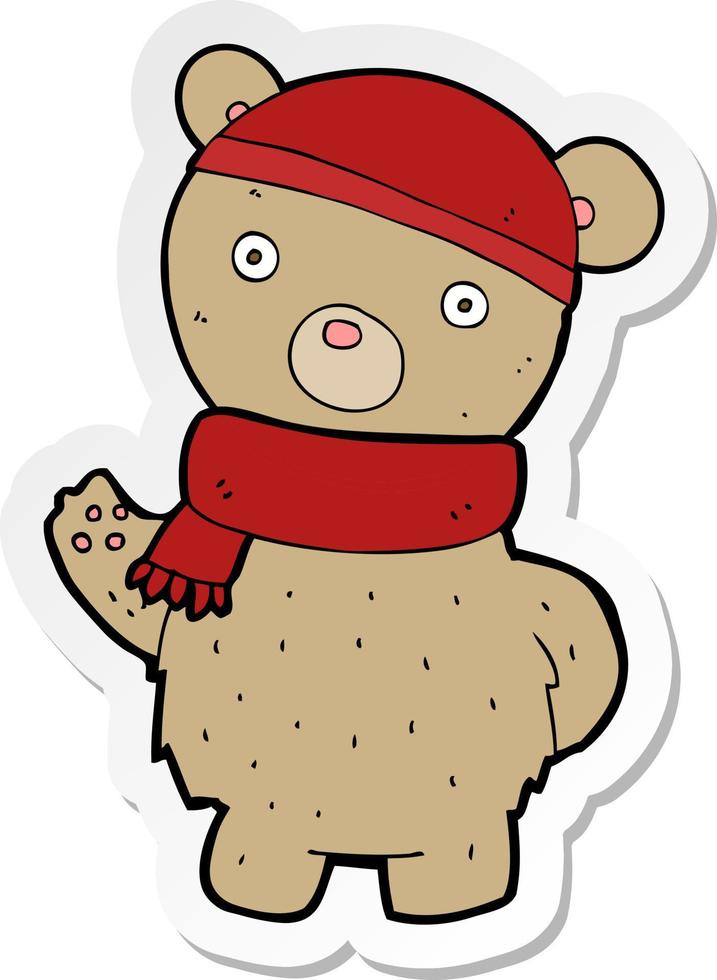 pegatina de un oso de peluche de dibujos animados con gorro y bufanda de invierno vector