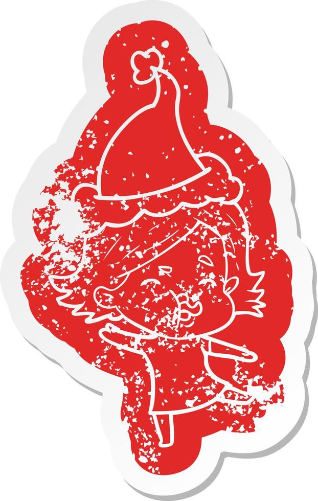 cartoon distressed sticker of a girl pulling face wearing santa hat vector