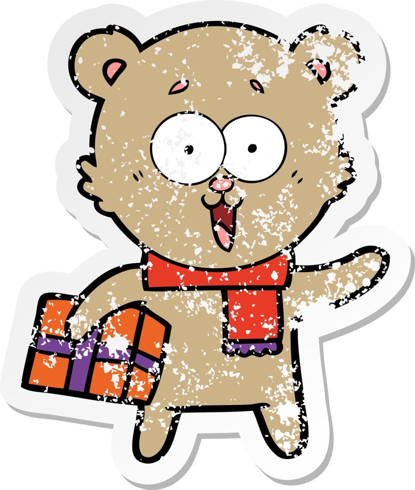 distressed sticker of a laughing teddy  bear with christmas present vector