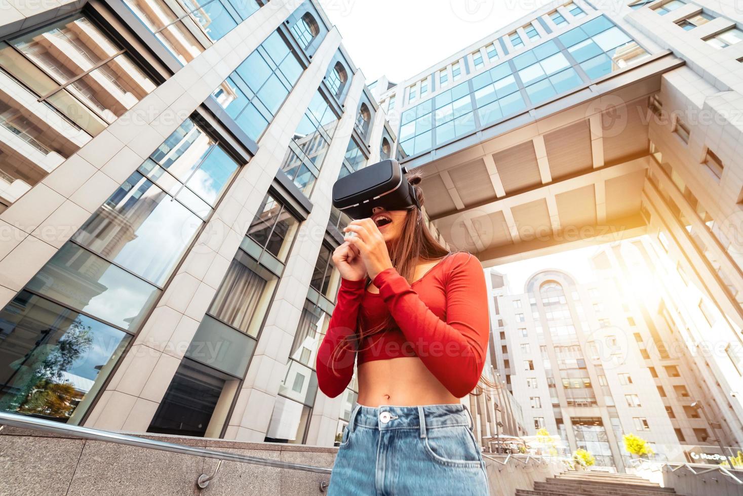 Woman in a virtual reality helmet walks down the street photo