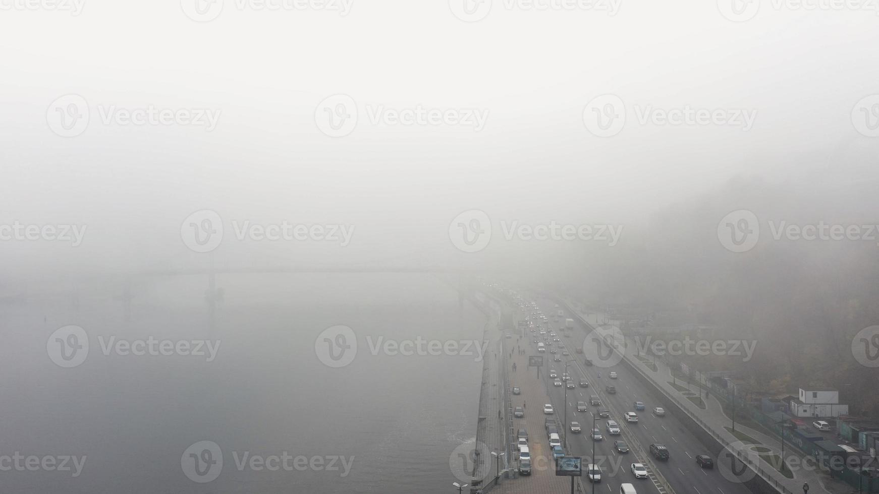 A city covered in fog. City traffic, aerial view photo