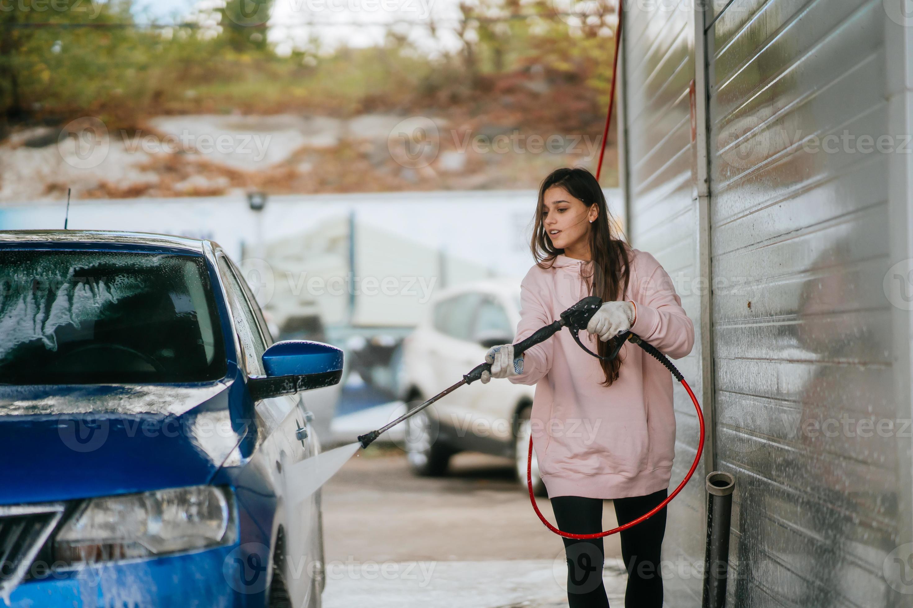 Young woman washing blue car at car wash 11752283 Stock Photo at Vecteezy