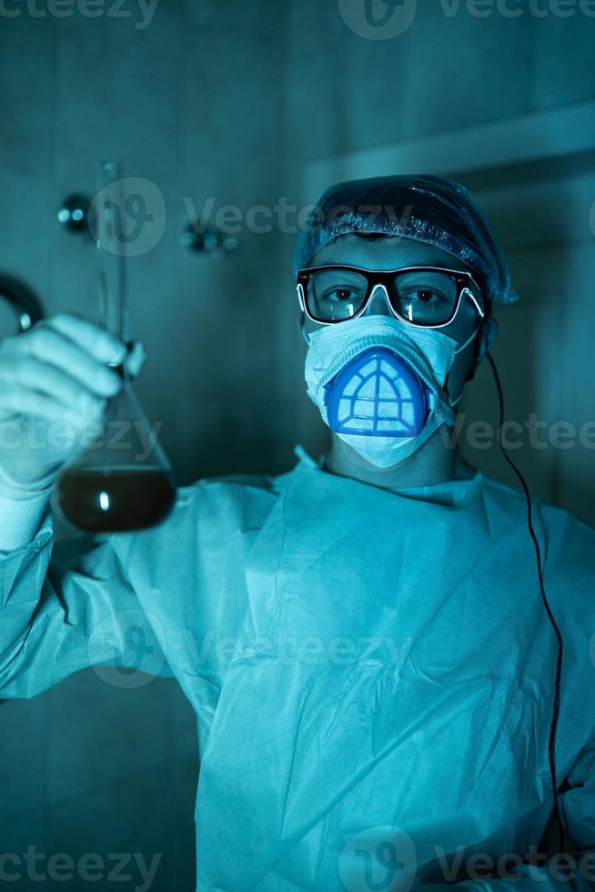 Young male researcher carrying out scientific experiment. photo