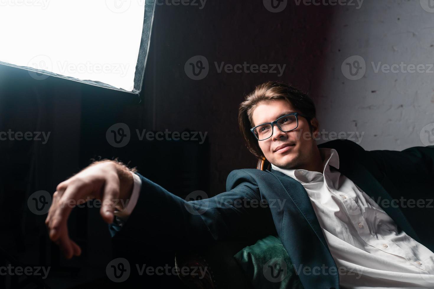 close-up portrait of an attractive young man relaxing on the couch photo