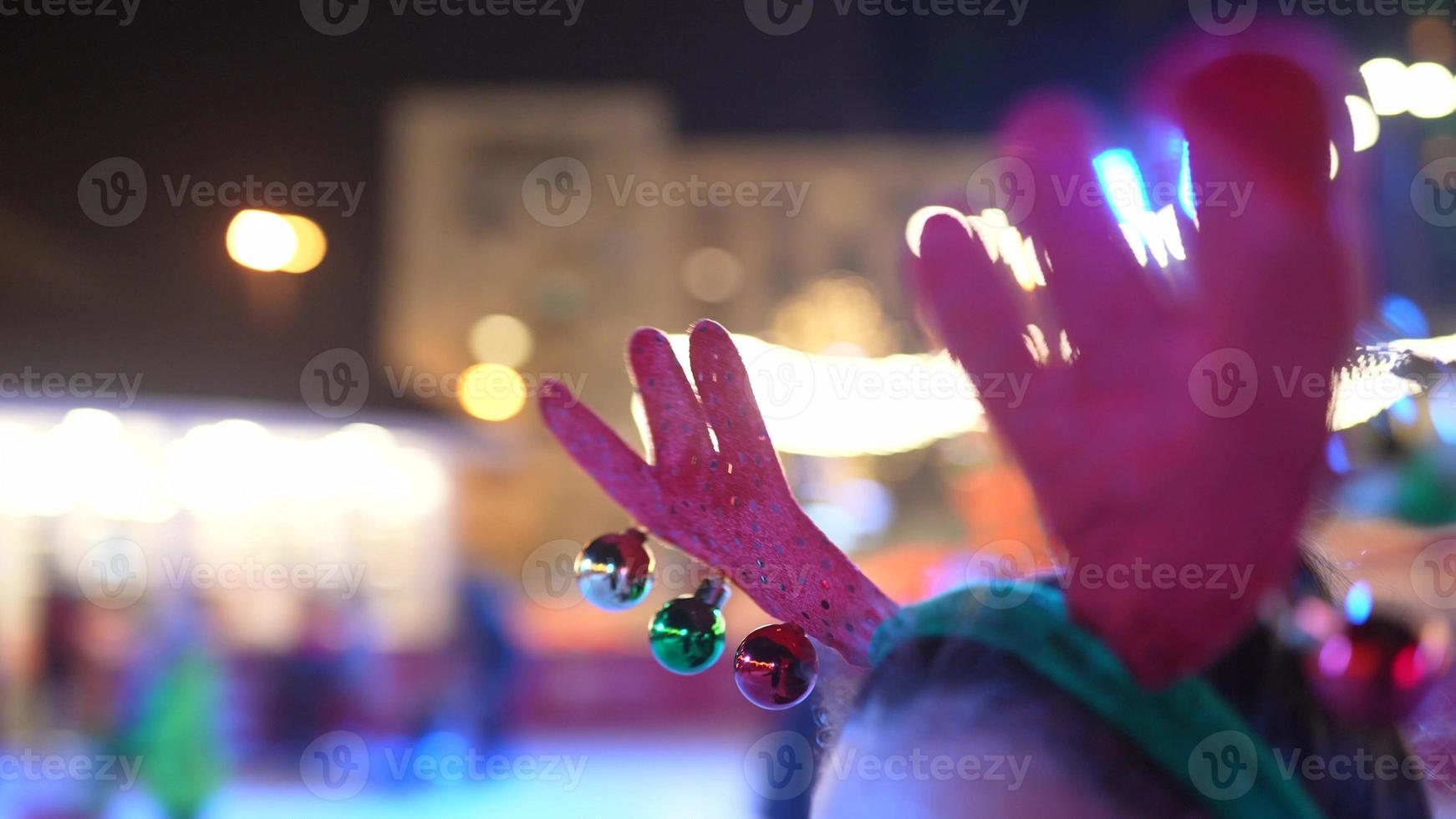 People enjoy ice skating in the street around Christmas tree in rink. photo