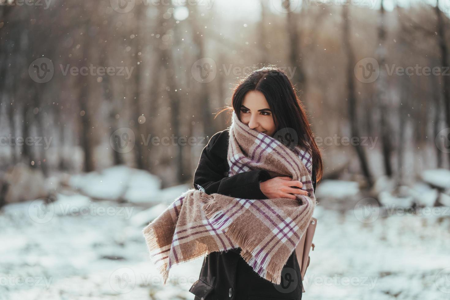 Young beautiful model posing in winter forest. stylish fashion portrait photo