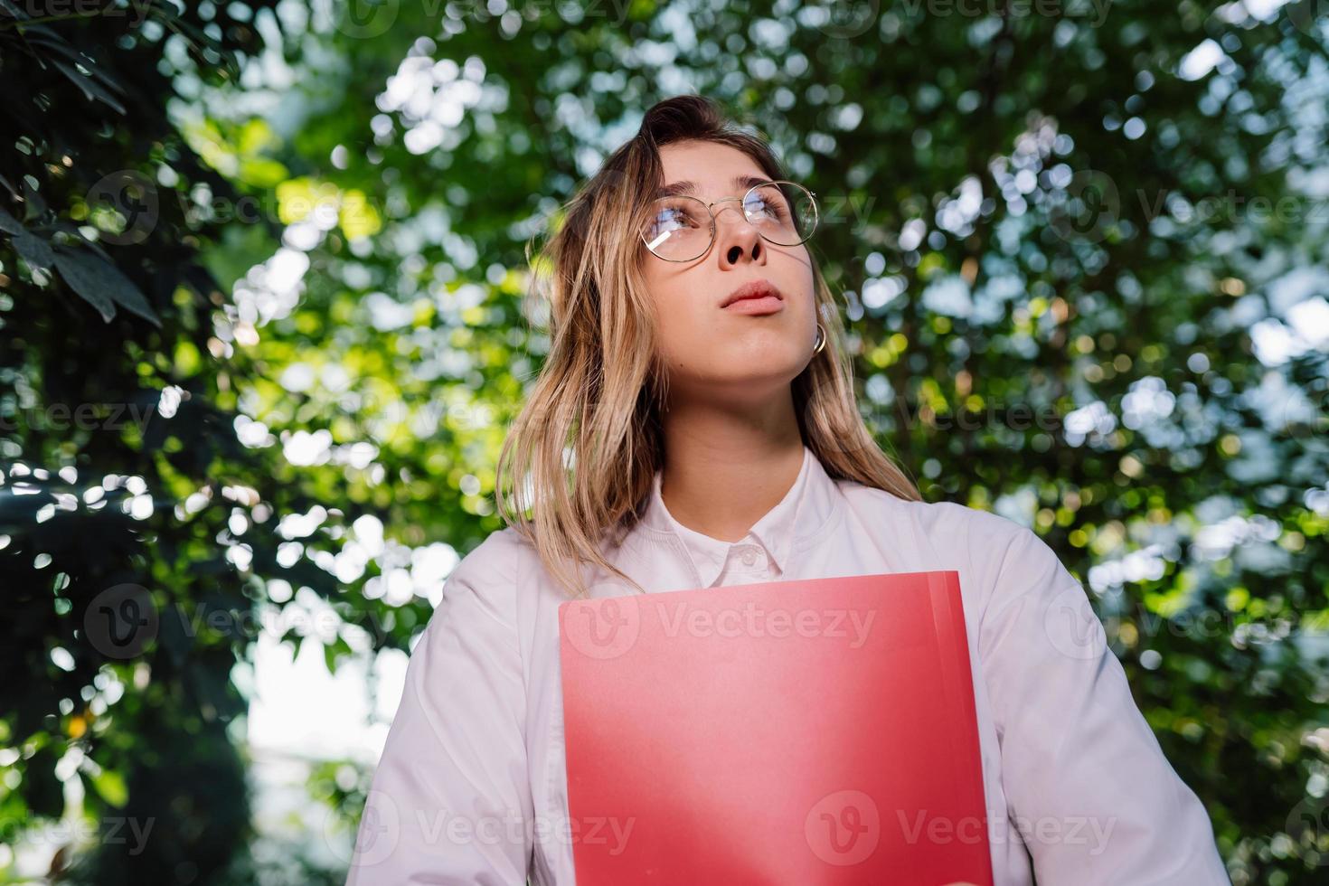 Young female agricultural engineer working in greenhouse. photo