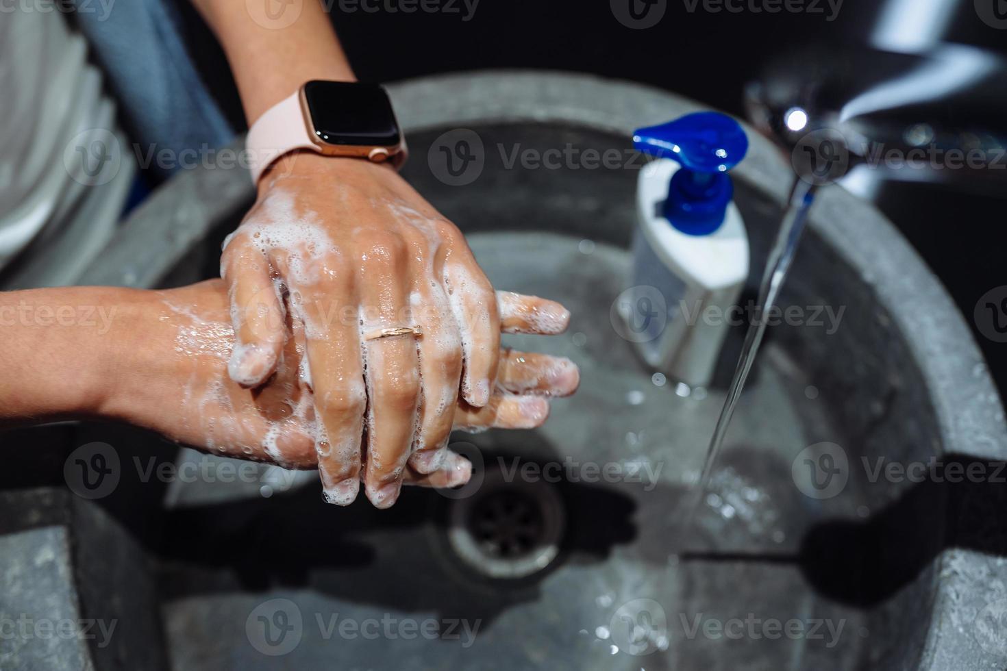 Man washing hands to protect against the coronavirus photo