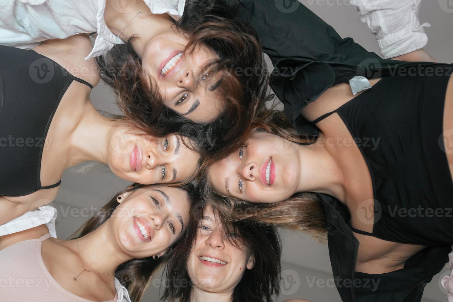 View from below. Diverse models around the camera photo