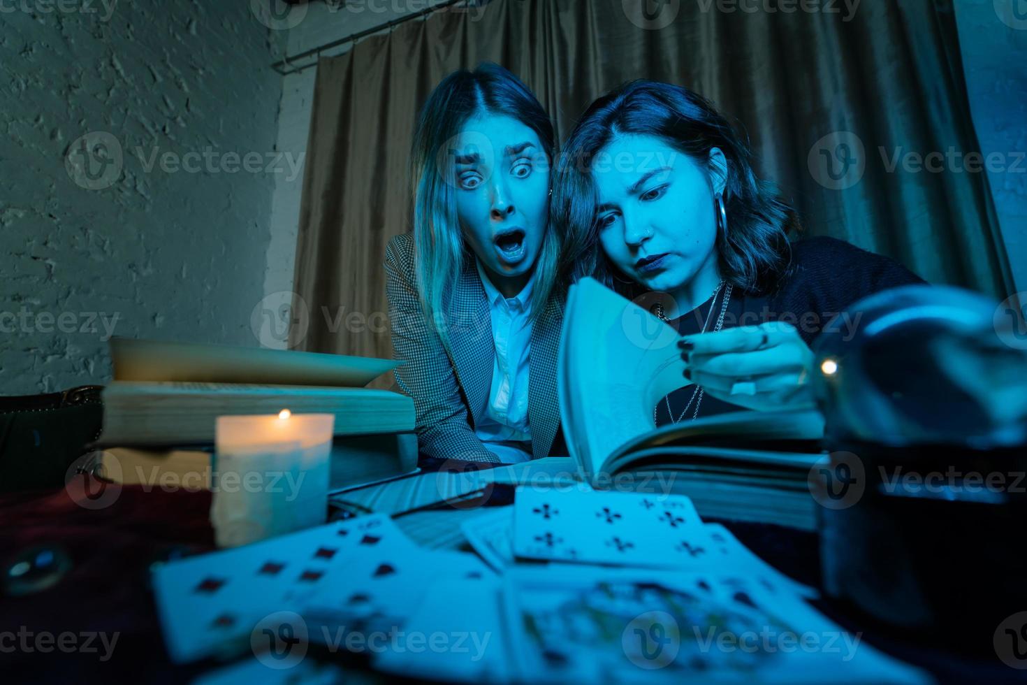Two women are reading a mysterious book photo