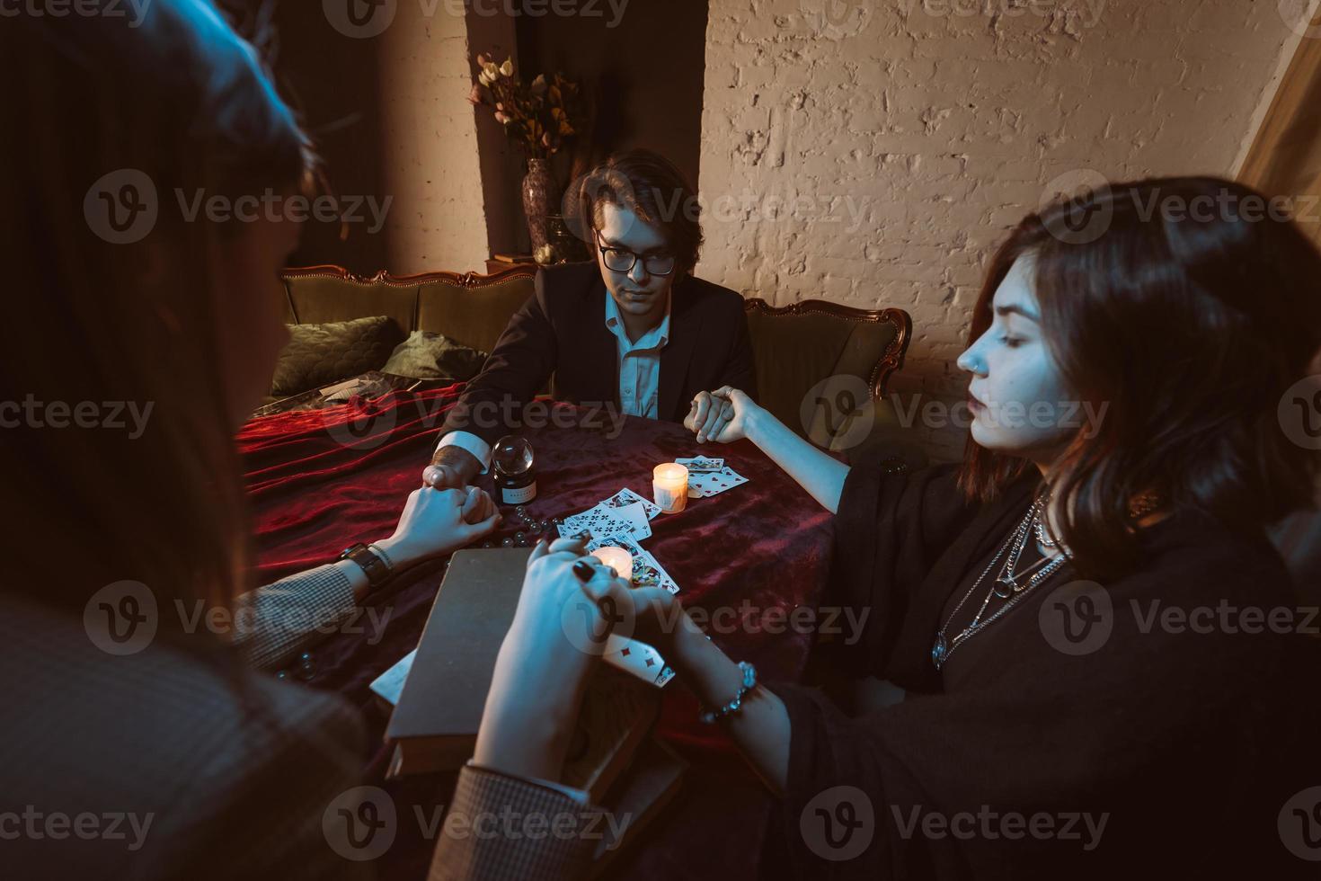 People hold hands of night at table with candles photo