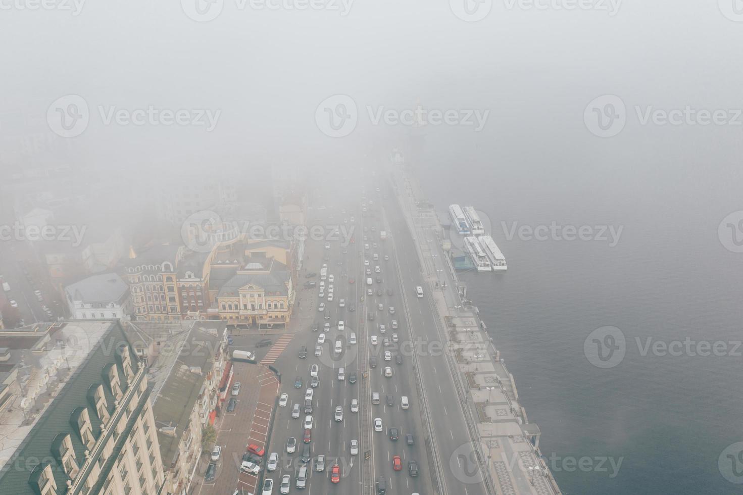 A city covered in fog. City traffic, aerial view photo