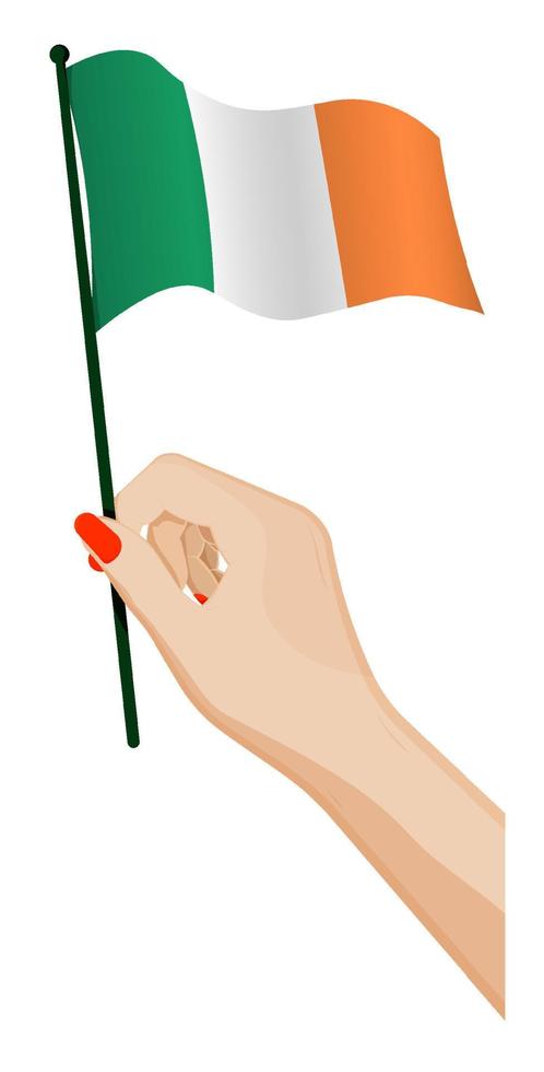 Female hand gently holds small irish flag. Holiday design element. Cartoon vector on white background