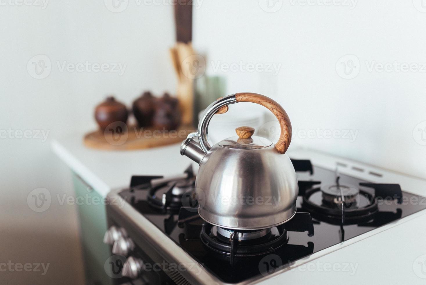 Kettle on the gas stove. Interior of modern kitchen photo