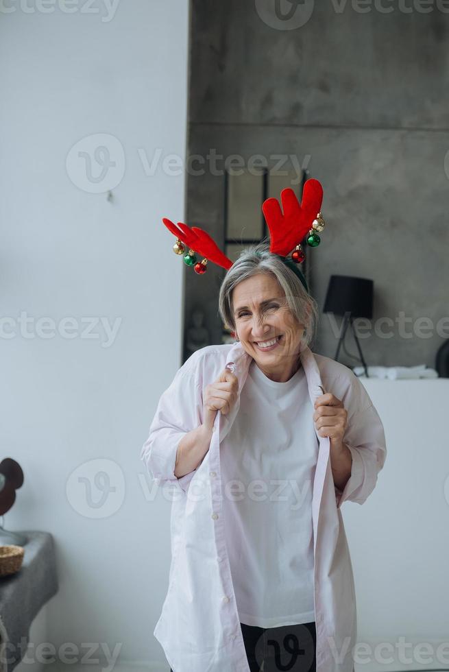 Grandma wearing deer christmas hat, happy smiling face photo