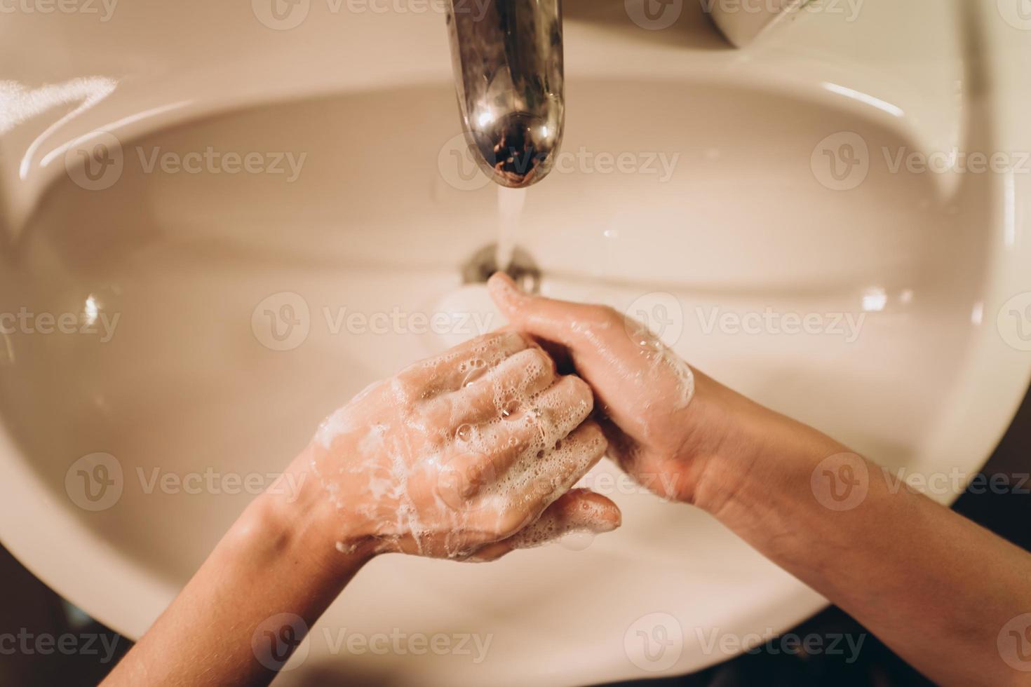 Man washing hands to protect against the coronavirus photo