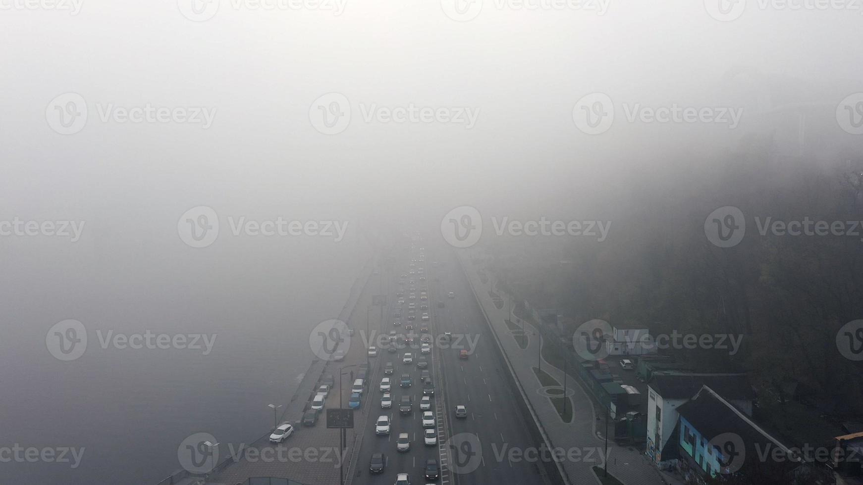 A city covered in fog. City traffic, aerial view photo