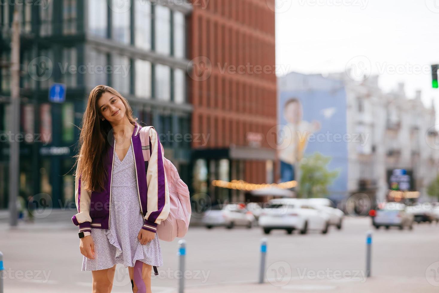 Playful portrait of pretty young woman, having fun at the street. photo