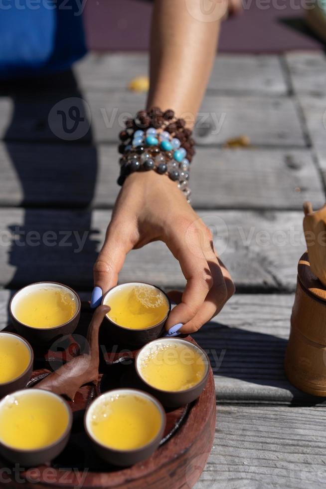 Top view tea set a wooden table for tea ceremony background. Woman and man holding a cup of tea photo