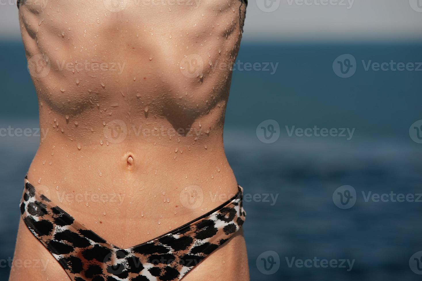 Torso of slim attractive female with flat belly in white underwear. photo