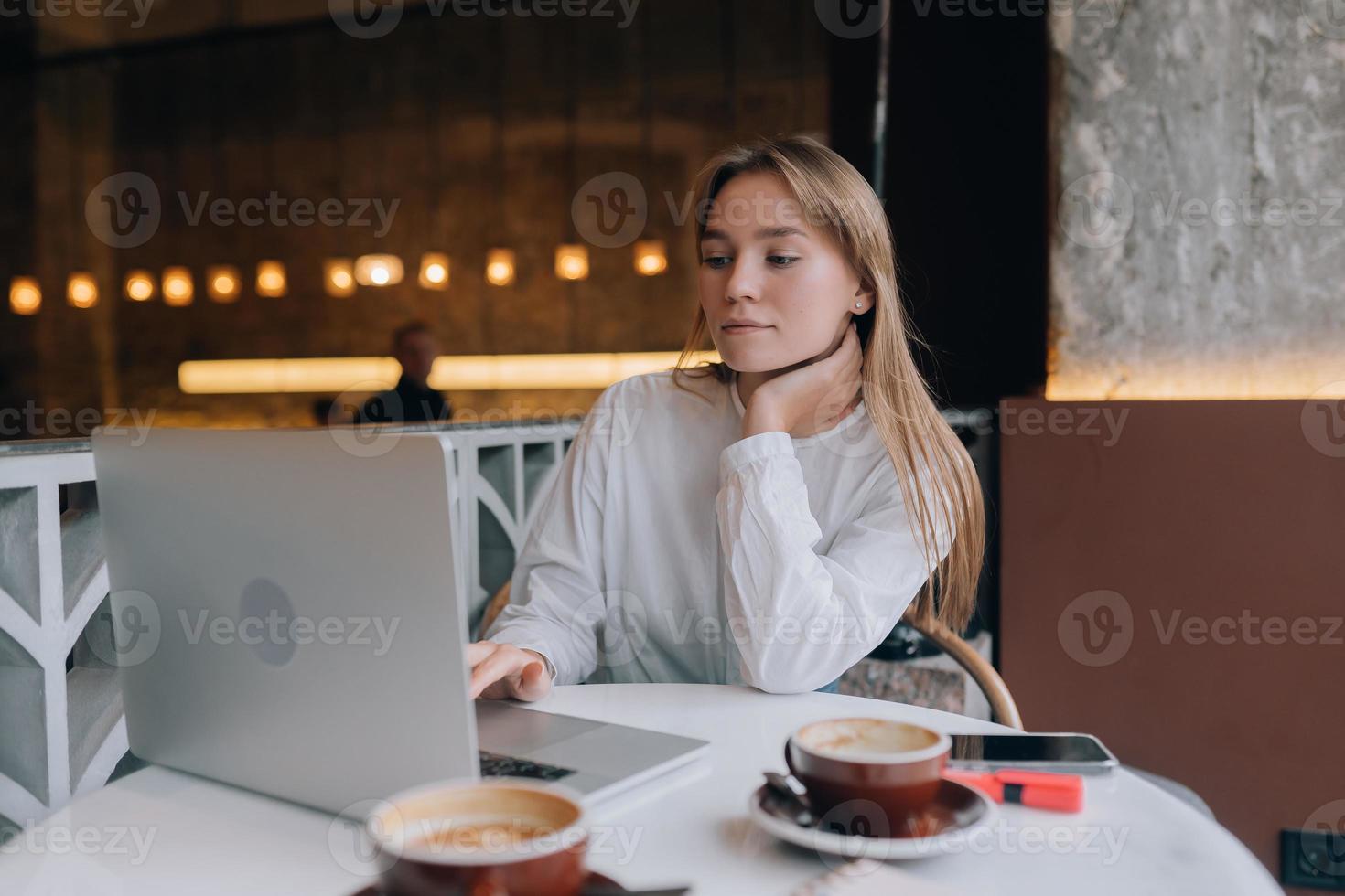 Young lady browsing the Internet at the cafe photo