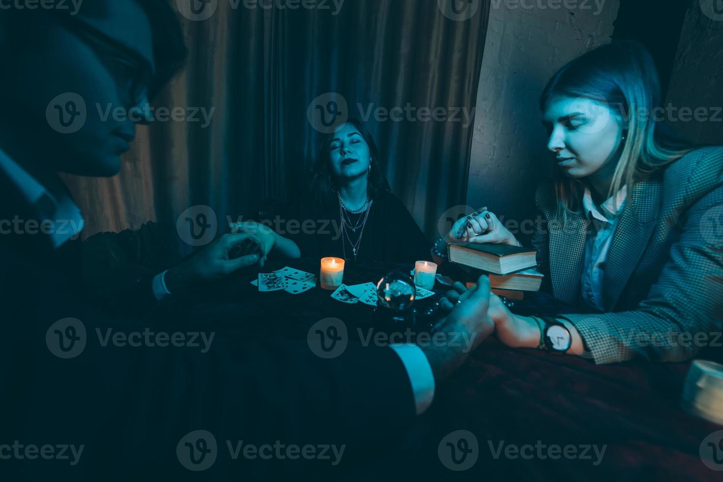 People hold hands of night at table with candles photo