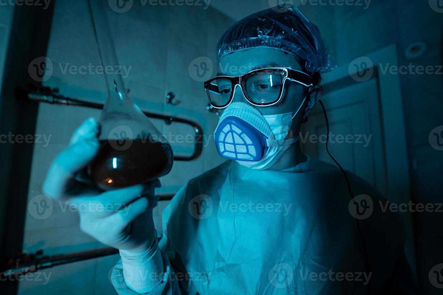 Young male researcher carrying out scientific experiment. photo