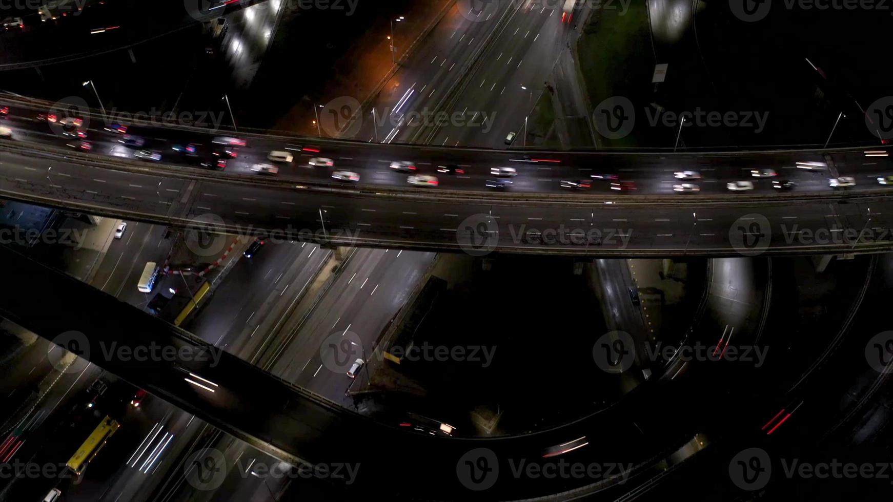 Aerial view of highway interchange at night, timelapse. photo