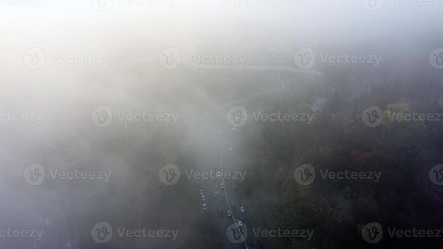 A city covered in fog. City traffic, aerial view photo