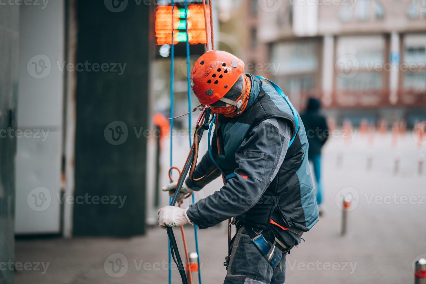 Worker climber preparing for work at height. photo
