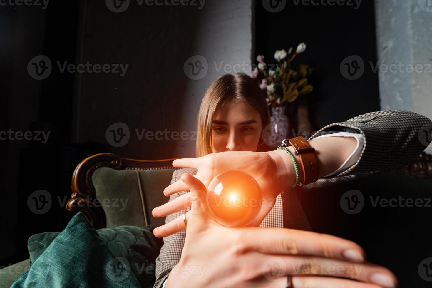 Woman in business suit holding crystal ball photo