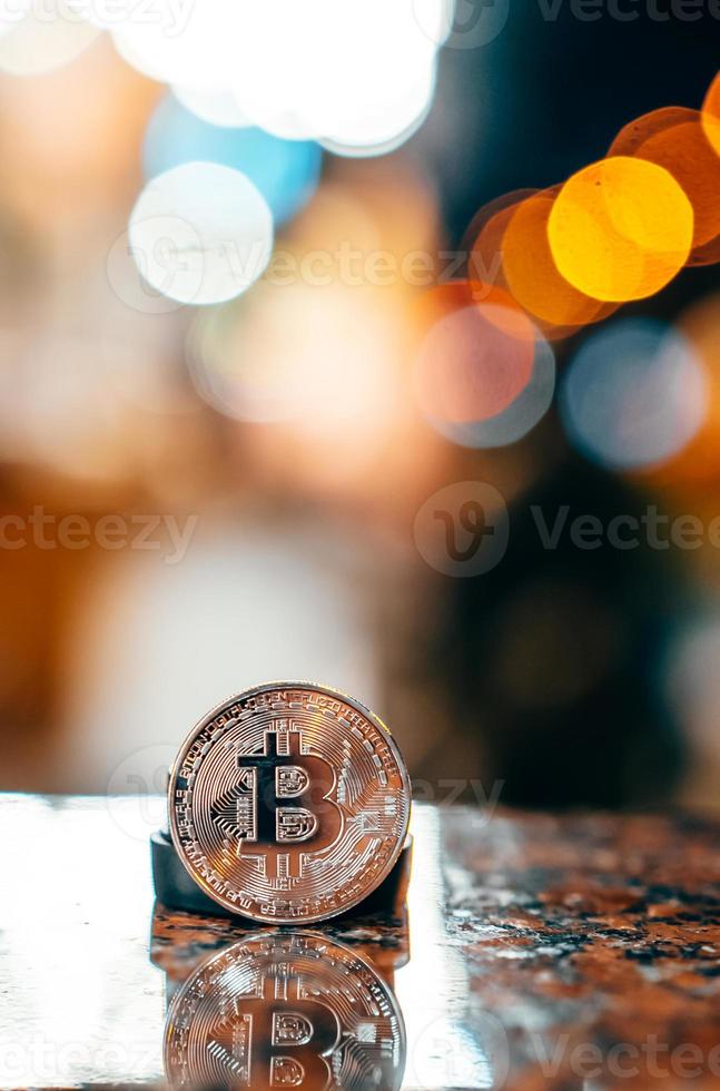 Silver bitcoin isolated on the table, glowing background photo