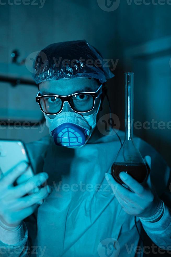 Young male researcher carrying out scientific experiment. photo