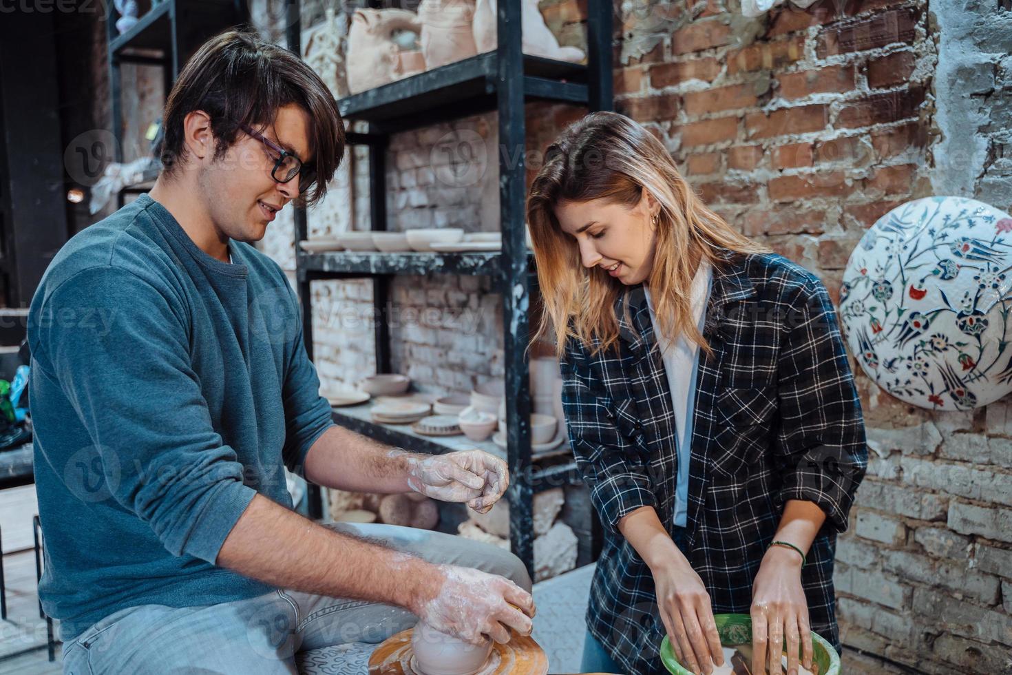 Making a handmade clay pot in the workshop. Pottery lesson, hobby. photo