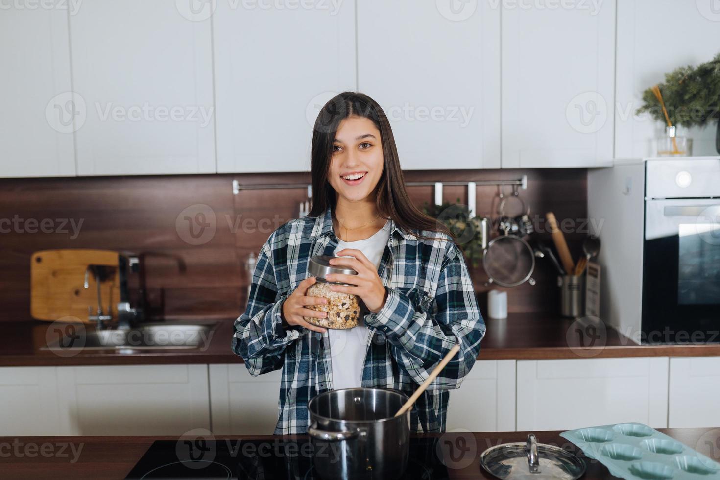 Young woman is preparing food in the kitchen. Prepare Food. photo