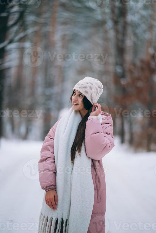 niña de pie en medio del camino cubierto de nieve. foto