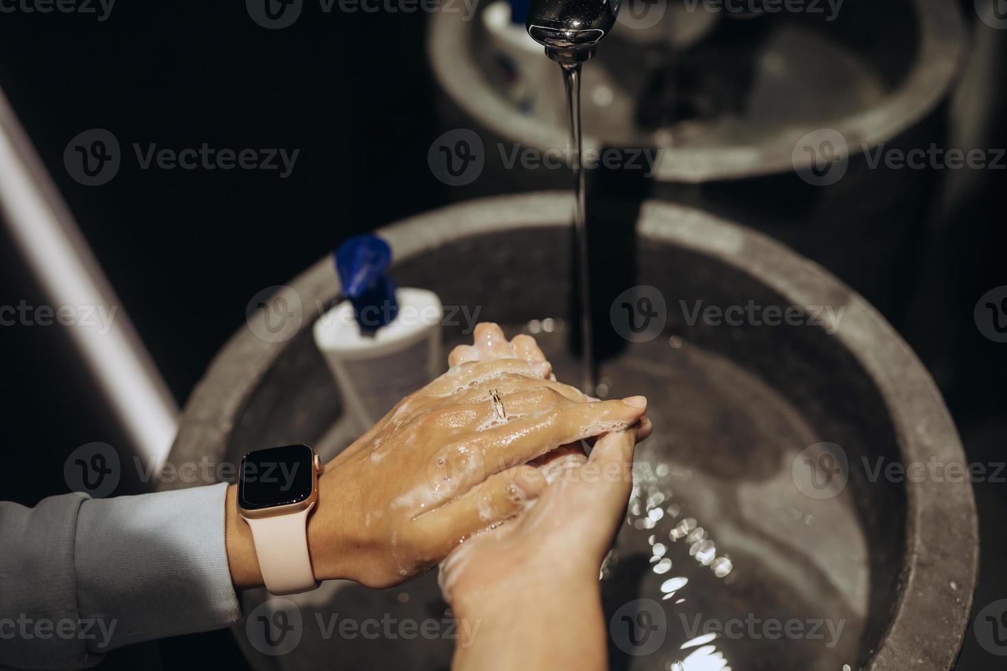 Man washing hands to protect against the coronavirus photo