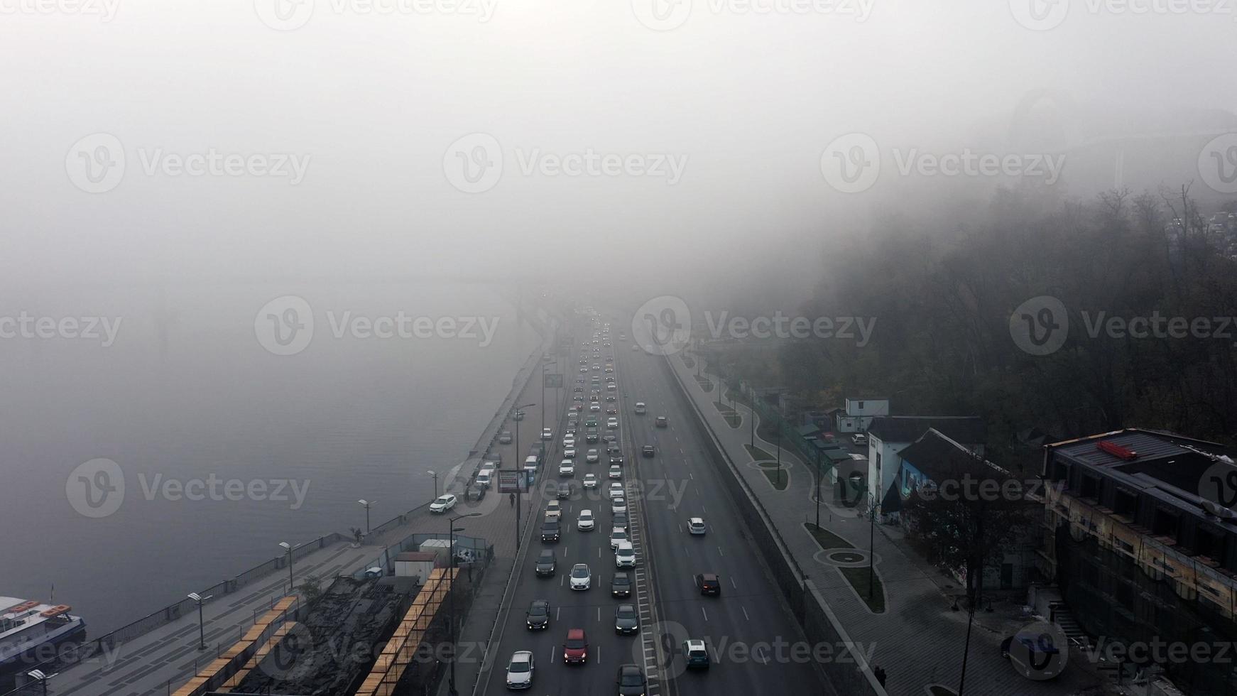 A city covered in fog. City traffic, aerial view photo